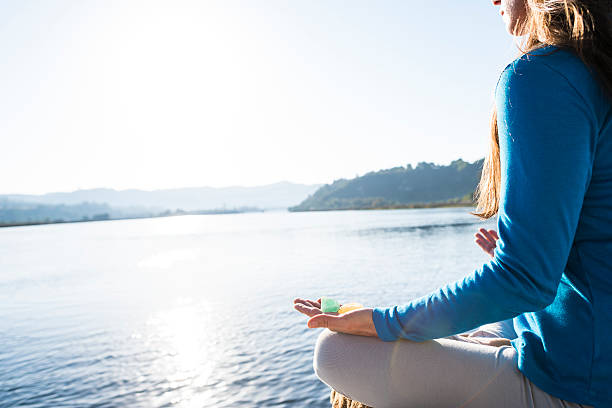 istock Woman Meditating On A Calm Lake 628108458