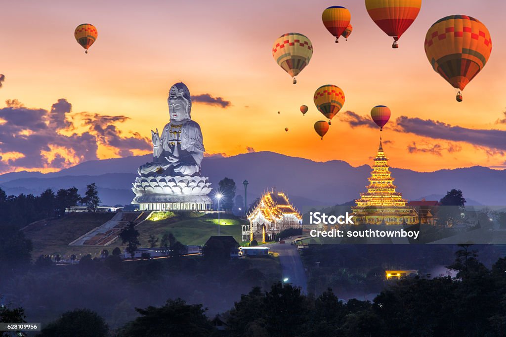 Colorful hot air balloons flying over Wat Huay Pla Kang Colorful hot air balloons flying over Wat Huay Pla Kang, Chinese temple in Chiang Rai Province, Thailand Thailand Stock Photo