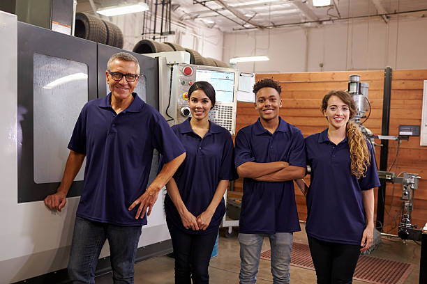 istock Portrait Of Engineer Training Apprentices On CNC Machine 628110542