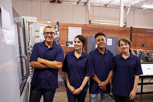 istock Portrait Of Engineer Training Apprentices On CNC Machine 628110554