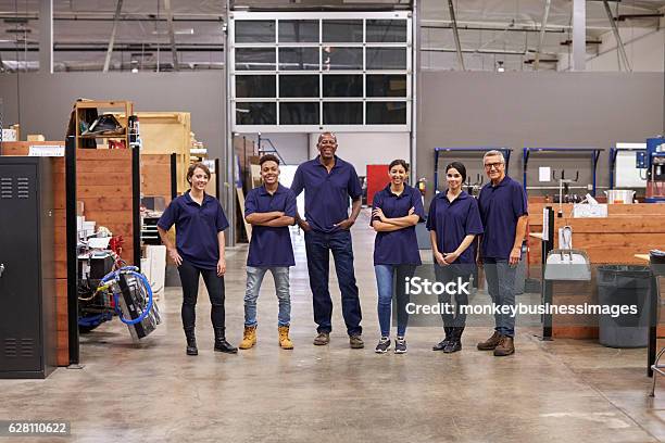 Portrait Of Engineers And Apprentices In Busy Factory Stock Photo - Download Image Now