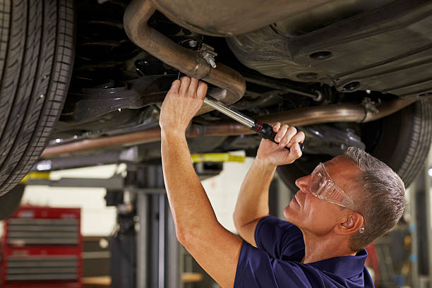 istock Auto Mechanic Working Underneath Car In Garage 628110712
