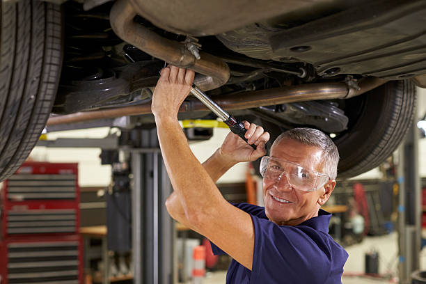 istock Portrait Of Auto Mechanic Working Underneath Car In Garage 628110720