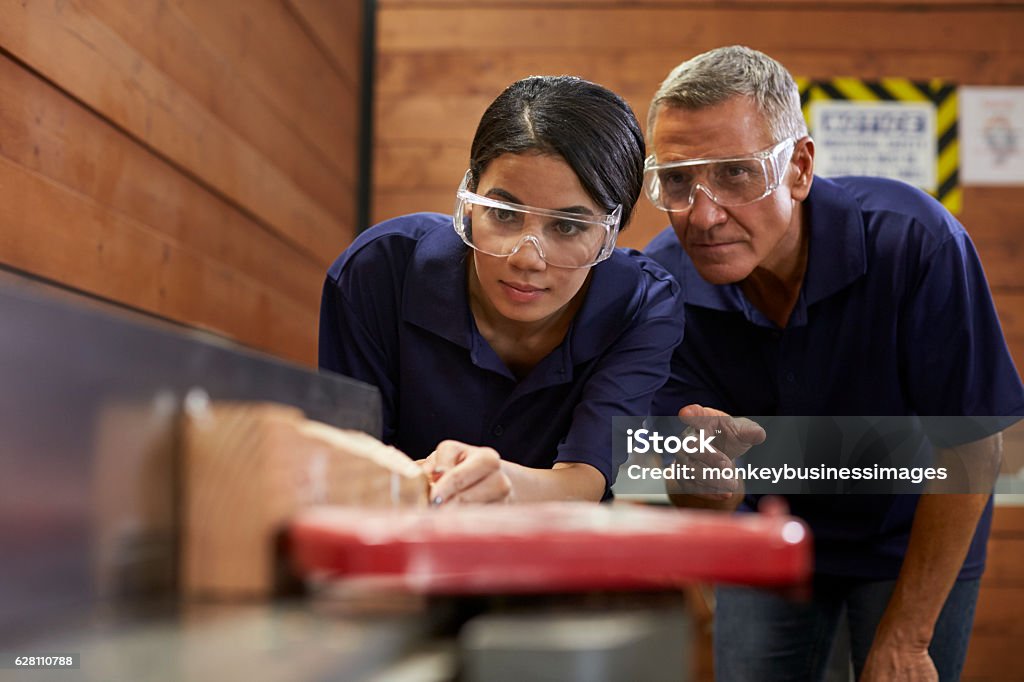 Carpenter Training Female Apprentice To Use Plane Trainee Stock Photo