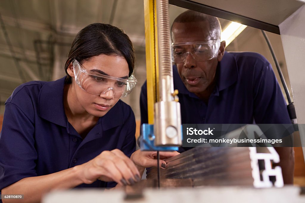 Carpenter Training Female Apprentice To Use Mechanized Saw Education Training Class Stock Photo