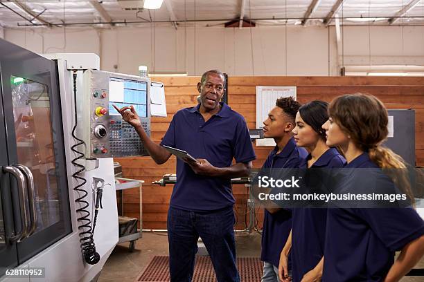 Engineer Training Apprentices On Cnc Machine Stock Photo - Download Image Now - Education Training Class, Occupation, Working