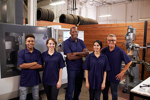 istock Portrait Of Engineers And Apprentices With CNC Machine 628110976