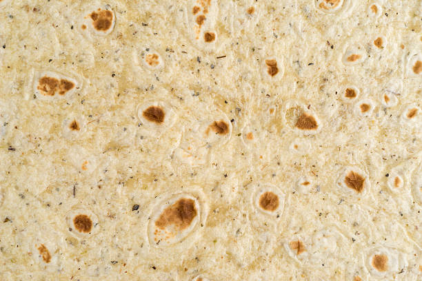 istock Close view of a garlic and herb flavored tortilla wrap 628111332