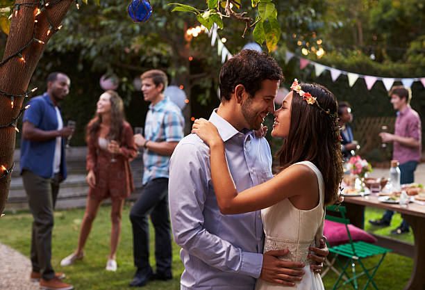 istock Young Couple Celebrating Wedding With Party In Backyard 628111776