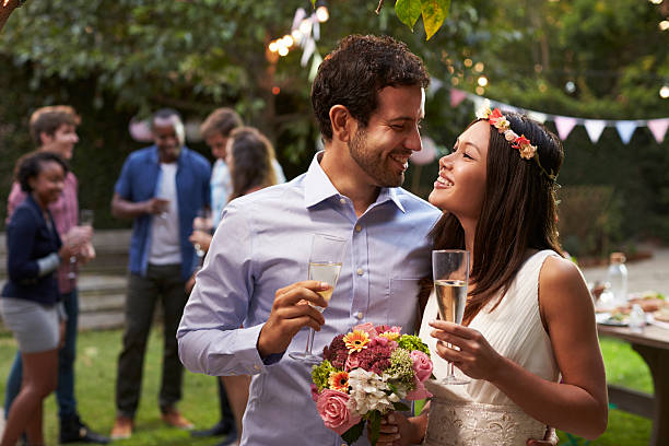 istock Young Couple Celebrating Wedding With Party In Backyard 628111802