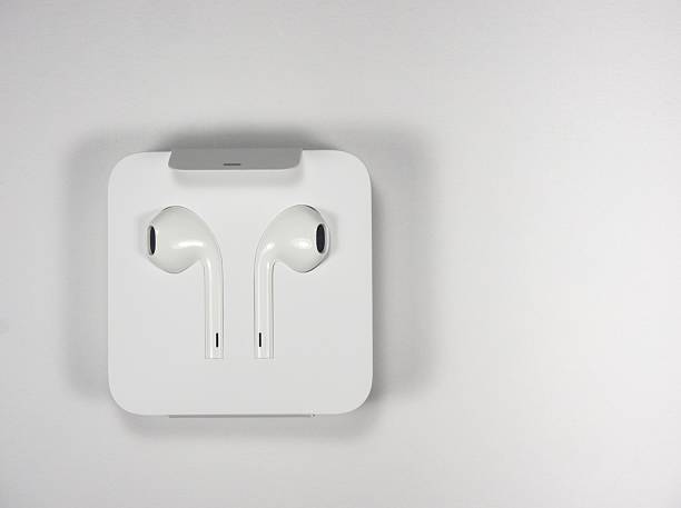 istock White earphones in a box on white background 628112124
