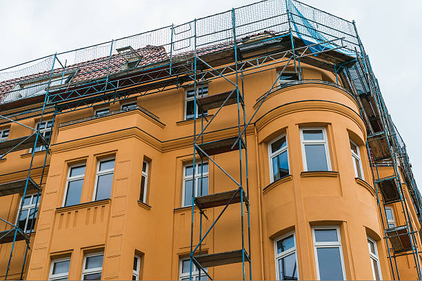 istock orange facaded building with construction on the roof 628117514