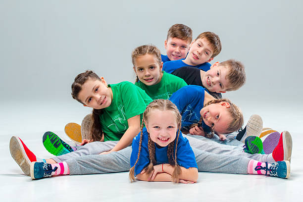 The kids dance school, ballet, hiphop, street, funky and modern The kids dance school, ballet, hiphop, street, funky and modern dancers on gray studio background jumping teenager fun group of people stock pictures, royalty-free photos & images