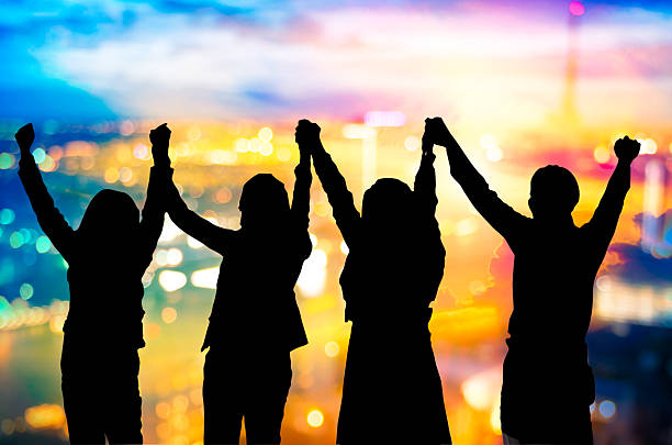 istock Silhouette of happy business team making high hands 628119220