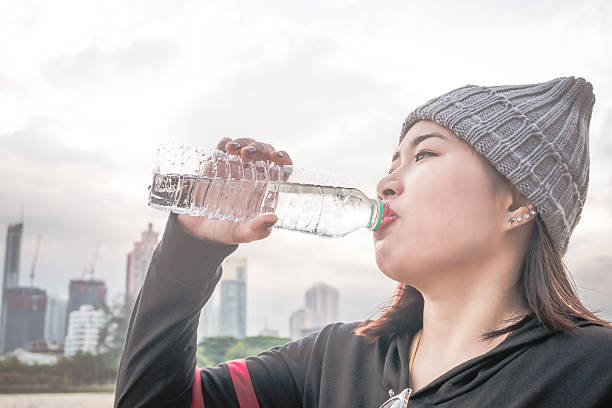 istock Young woman drinking water after exercising. 628119890