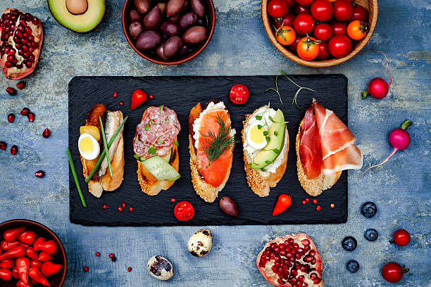 Brushetta or authentic traditional spanish tapas. Mini sandwiches food set Mini sandwiches food set. Brushetta or authentic traditional spanish tapas for lunch table. Delicious snack, appetizer, antipasti on party or picnic time. Top view. spanish breakfast stock pictures, royalty-free photos & images