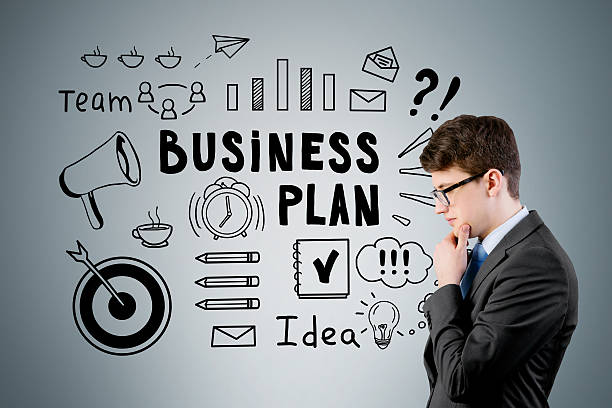 istock businessman in glasses near a business plan sketch 628120568