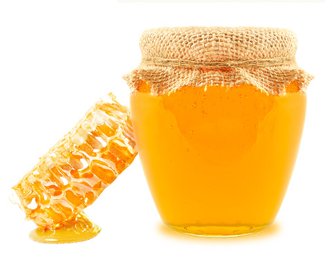 honey in a jar and honeycomb isolated on white background