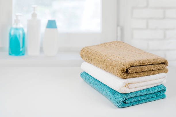 bath towel pile on wood over defocused bathroom windowsill background - liquid soap blue plastic textile imagens e fotografias de stock