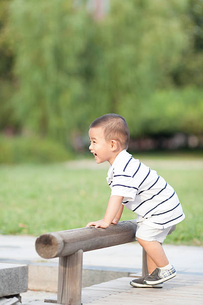 istock Happy Chinese baby boy playing in a park 628124912