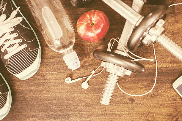 istock Fitness, exercise themed scene with barbells, sneakers, earbuds. 628125114