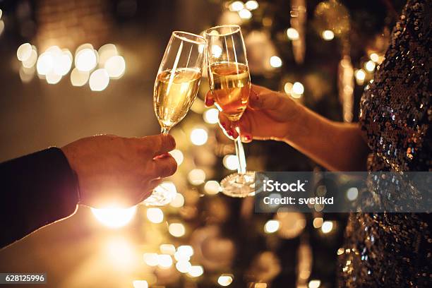 Celebrating With Bubbly Stock Photo - Download Image Now - Champagne, Celebratory Toast, Christmas