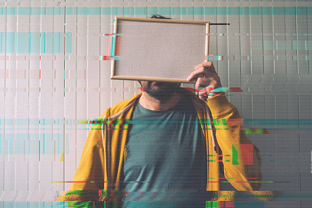 Unrecognizable man posing with blank picture frame over his face Unrecognizable man posing with blank picture frame over his face as copy space, digital glitch effect added in post production person holding frame over face stock pictures, royalty-free photos & images