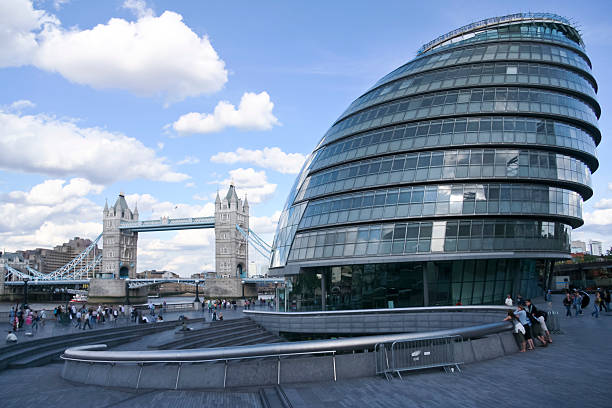London, UK - July 29, 2007: View of City Hall and Tower Bridge with Unidentified people in London. City hall is the office of the mayor.
