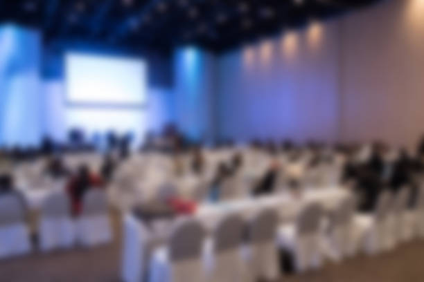 istock people sit on rows of chairs in large conference convention 628136766