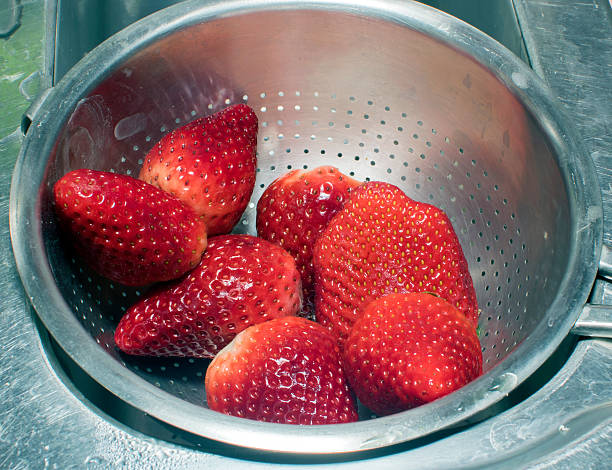 istock Strawberries in a colander on the kitchen sink. 628139274