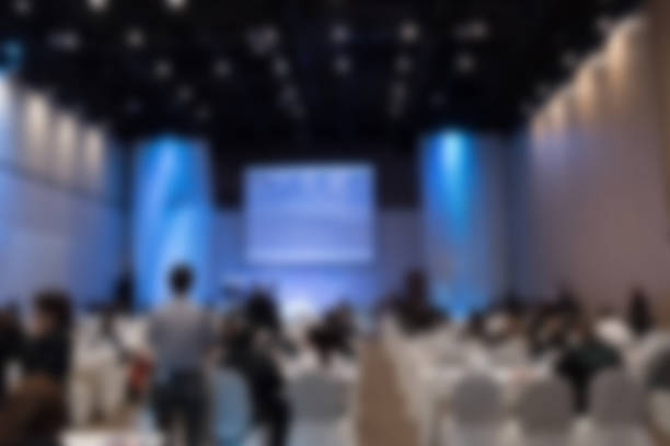 istock people sit on rows of chairs in large conference convention 628139734