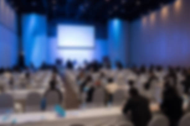 istock people sit on rows of chairs in large conference convention 628139764