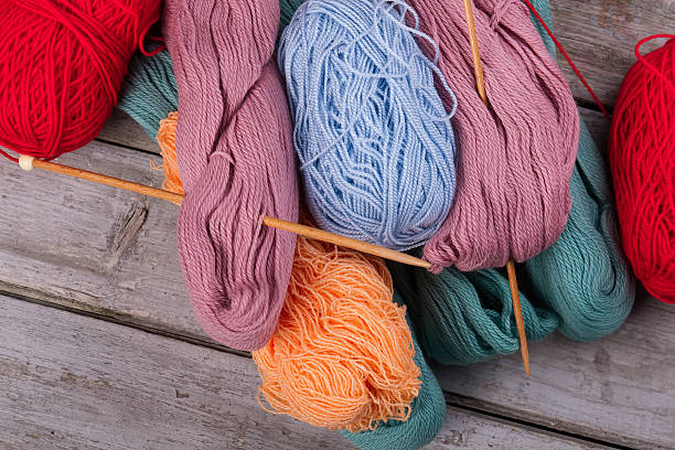 istock Many multicolored yarn with wooden knitting needles. 628140770