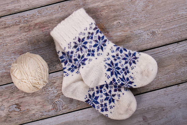 istock Beautiful white woolen socks with blue ornaments. 628146796