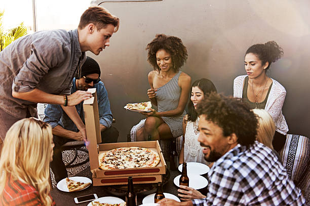istock Group of friends having beers and pizza 628147460