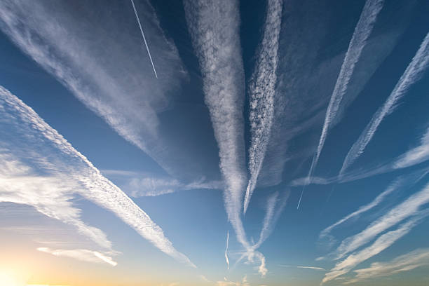 cloudscape showing trails left by airplanes - rasto de fumo de avião imagens e fotografias de stock