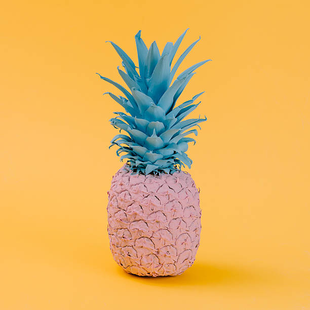 istock Pink pineapple on yellow background. Minimal style. Food concept 628156368