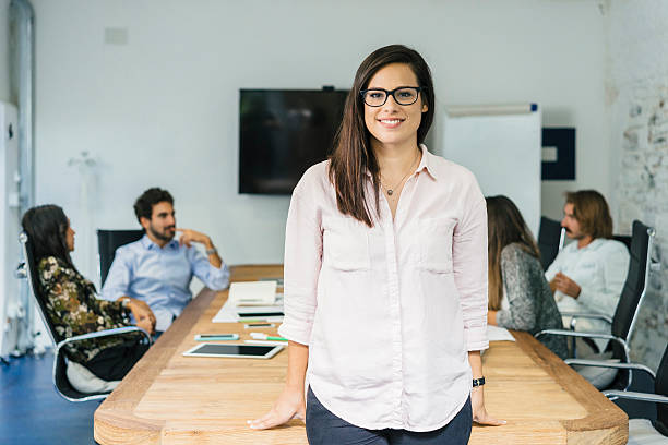 istock Beautiful Young Woman Showing her Startup Team 628156738