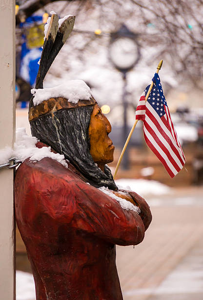 The Humbled American Indian An indian figure outside a Golden Colorado mercantile store that is chained to a post and frozen. colorado flag art pictures stock pictures, royalty-free photos & images