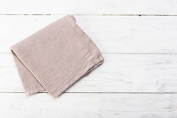 istock Gray napkin isolated on white wooden table. Copy space. Brick 628158824