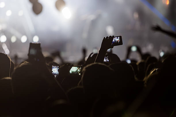 istock Hand with a smartphone records live music festiva 628159530