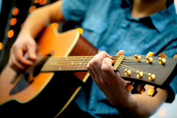istock Man playing an acoustic guitar during a concert 628159856
