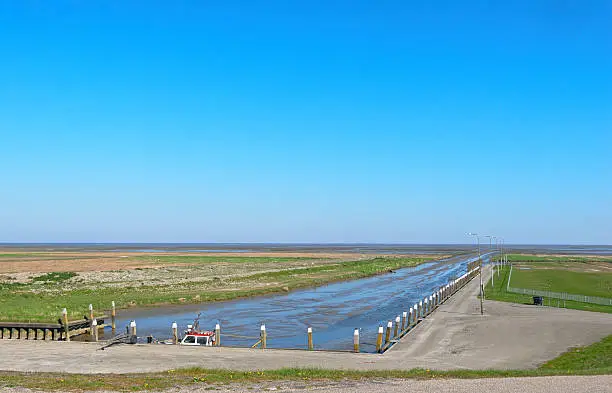 The very small tidal sea harbor of Noordpolderzijl at the Wadden Sea. At the moment of this photo there is hardly any water due to low tide.