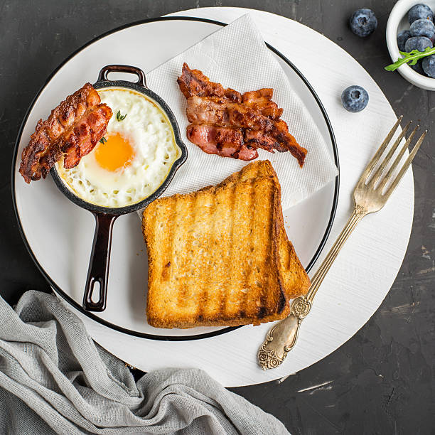istock Breakfast set. Pan of fried eggs with bacon and fresh 628162804