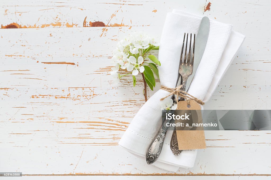 Spring table setting with white flowers Spring table setting with white flowers, copy space Above Stock Photo