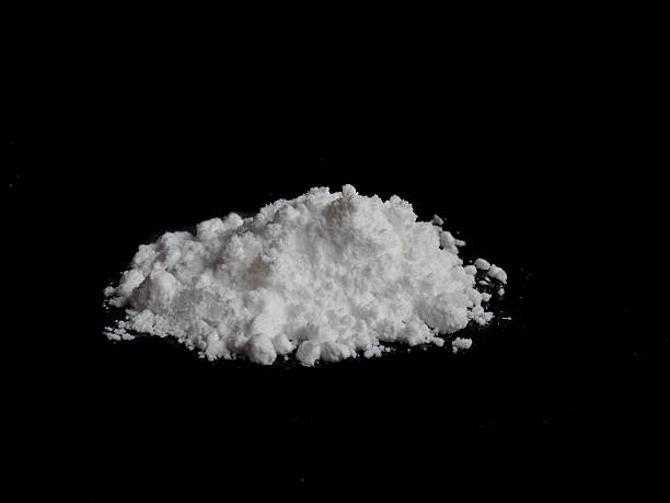 istock Cocaine drug powder pile on black background 628164932