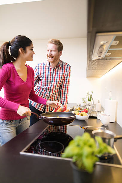 istock Young affectionate couple cooking healthy meal together and flirting 628166184