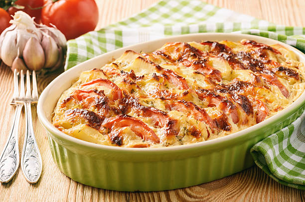 istock Vegetarian meal - potato casserole with tomatoes, garlic and cheese. 628167048