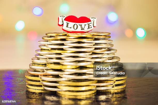 Pyramid Of Coins With The Inscription Love On Top Blurry Stock Photo - Download Image Now