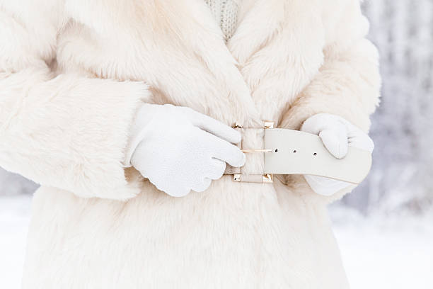 istock Woman wearing warm, soft fur coat and closing a belt. 628169862